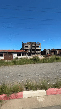Abandoned building complex observed from vehicle in Sredets, Bulgaria