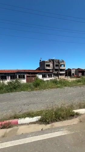 Abandoned building complex observed from vehicle in Sredets, Bulgaria