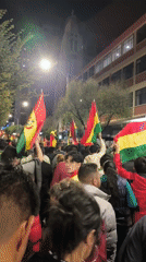Nighttime patriotic celebrations sweep La Paz streets with flag-waving crowds