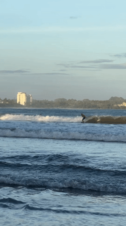 Surfers and beachgoers enjoy waves at Peleana, Sri Lanka