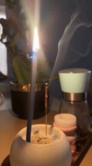 Blue candle and incense burning on tabletop in Kharnavy