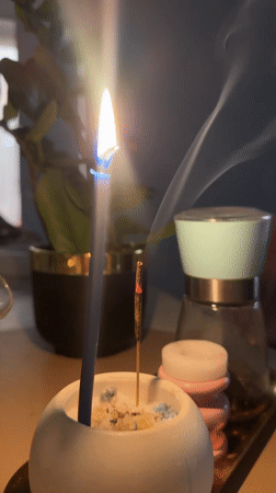 Blue candle and incense burning on tabletop in Kharnavy