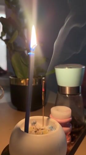 Blue candle and incense burning on tabletop in Kharnavy