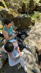 Young men relax by river in Vila Real, Portugal