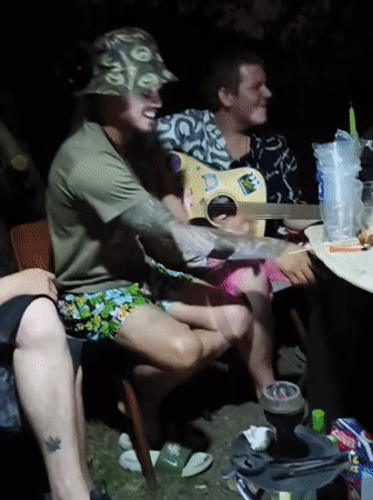 Late-night outdoor gathering in Prague with guitar and drinks