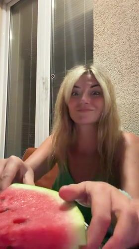 Balcony watermelon, a small white dog, and soccer on a laptop
