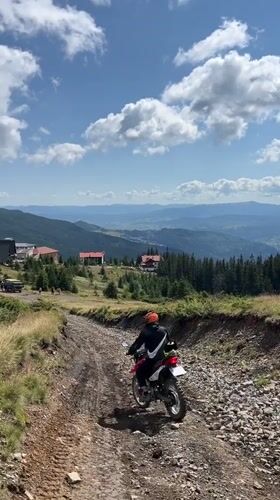 Dirt bike climbing a rocky mountain road in the Carpathians