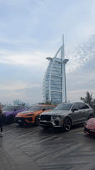 Luxury cars parked near Dubai's Burj Al Arab hotel