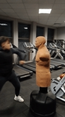 Late night gym training session with punching dummy