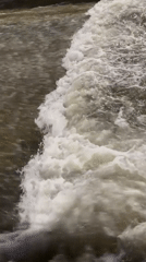 Water flows over dam structure in Almaty, Kazakhstan