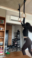Woman performs gymnastics rings workout at home in Bulgaria
