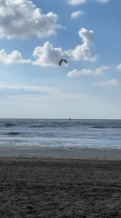 Kite surfer rides waves at The Hague beach