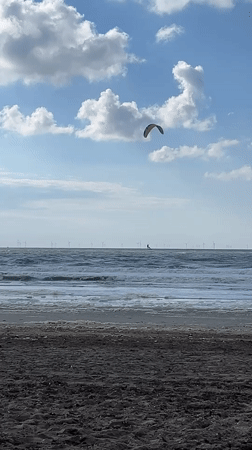 Kite surfer rides waves at The Hague beach