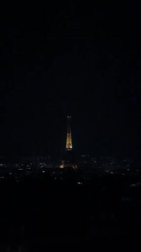 Eiffel Tower glowing gold against the Paris night sky