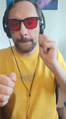 Close-up portrait in Izmail: yellow shirt, headphones, tinted shades