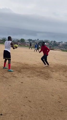 Pickup soccer on a dirt field in Jos, Nigeria