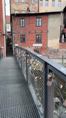 Love locks documented on Bydgoszcz bridge at dusk