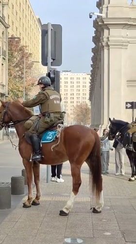 Mounted police patrol Santiago near presidential palace during evening hours
