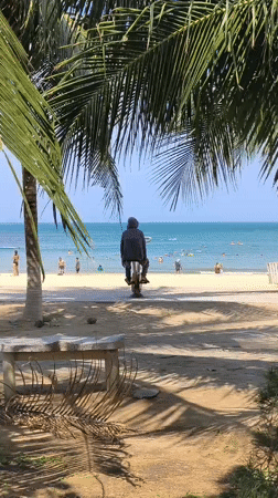 Unicycling on a Nha Trang beach under clear skies
