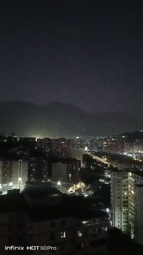 Evening scenes captured across Caracas showing cityscape and mountains