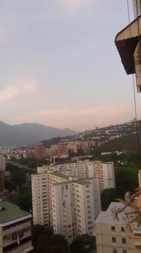 Caracas residents document sunset cityscape and rooftop pigeons