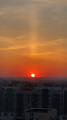 Sunset observed over Kazan cityscape with vertical light beam