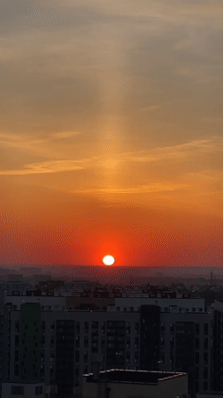 Sunset observed over Kazan cityscape with vertical light beam