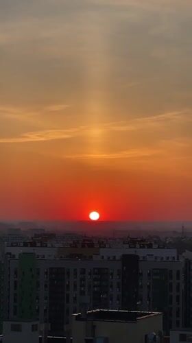 Sunset observed over Kazan cityscape with vertical light beam