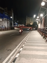 Mascot costume and night traffic on a Magetan street