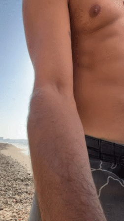 Man practices slacklining and juggling on Herzliya beach