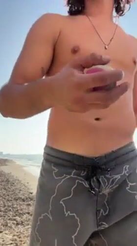 Man practices slacklining and juggling on Herzliya beach