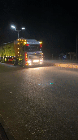 Trucks observed on nighttime street in Bukuru, Nigeria