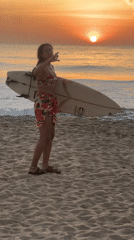 Golden hour on the Sri Lanka coast, surfboard in hand