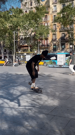 Skateboarder attempts trick in Barcelona public square
