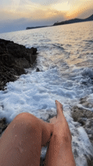 Tourists photograph sunset moments on Montenegro's rocky Luštica coastline