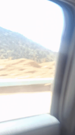 Vehicle travels through mountainous landscape in Tajikistan