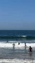 Santa Monica beachgoers enjoy sunny evening ocean activities