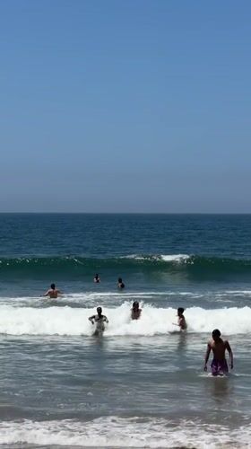 Santa Monica beachgoers enjoy sunny evening ocean activities