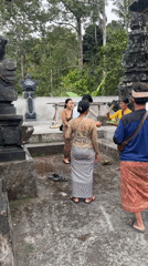 Morning gathering at carved stone temple complex in Busungbiu, Bali