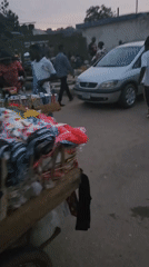 Person stands by parked minivan on Kabong street