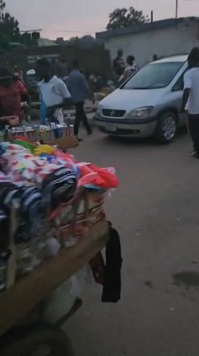 Person stands by parked minivan on Kabong street