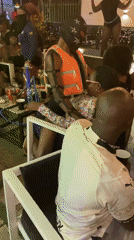 Nighttime social gathering with dancing and drinks in Jos