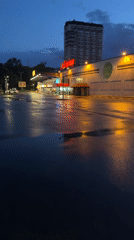 Evening rain creates reflective parking lot scene in Pleven