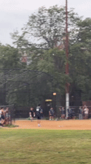 Pickup baseball game on a tree-lined New York park field.