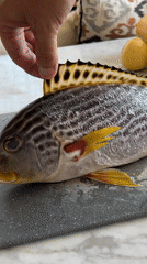 Fresh fish prep on a cutting board in Kuta Selatan