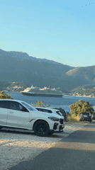 Scenic coastal road trip, golden hour, mountains and sea