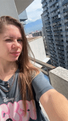 Woman takes selfies on sunny balcony in Batumi