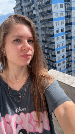 Woman takes selfies on sunny balcony in Batumi