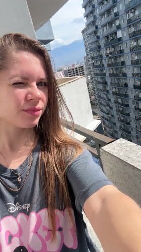 Woman takes selfies on sunny balcony in Batumi