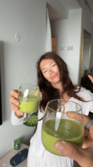 Two people toast with green smoothies in morning ritual